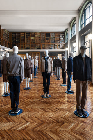 Double height historic library in a luxury hotel converted into a fashion showroom: a spacious hall with Hungarian herringbone parquet flooring